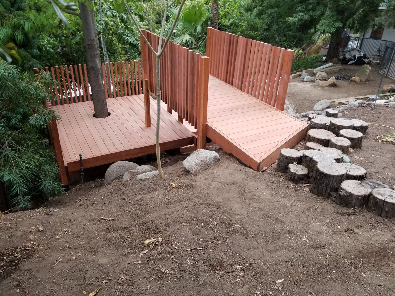Upper deck and ramp of the play structure among the trees