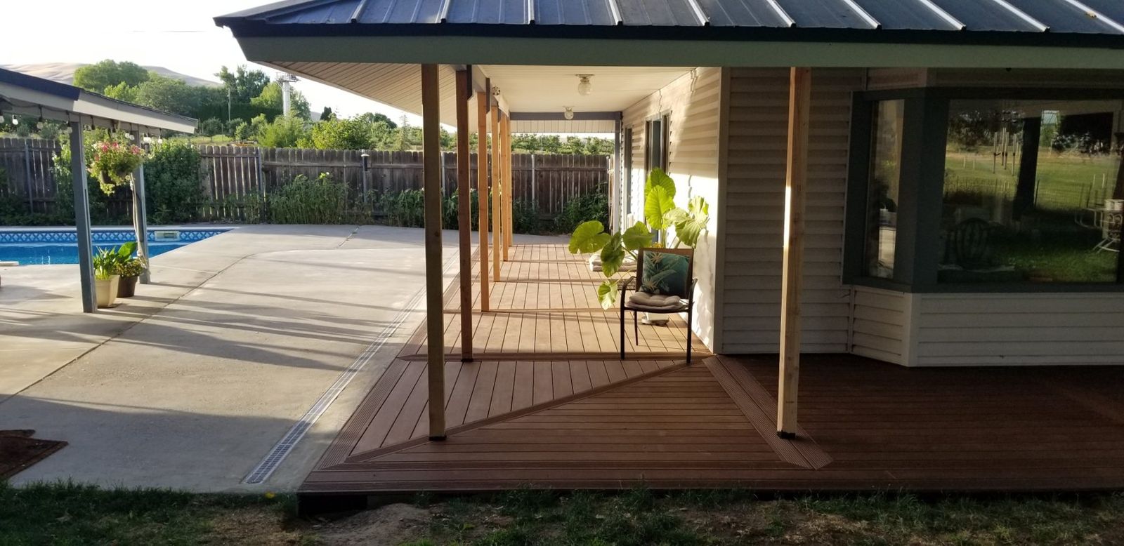 Bamboo deck running beside a pool under a covered patio