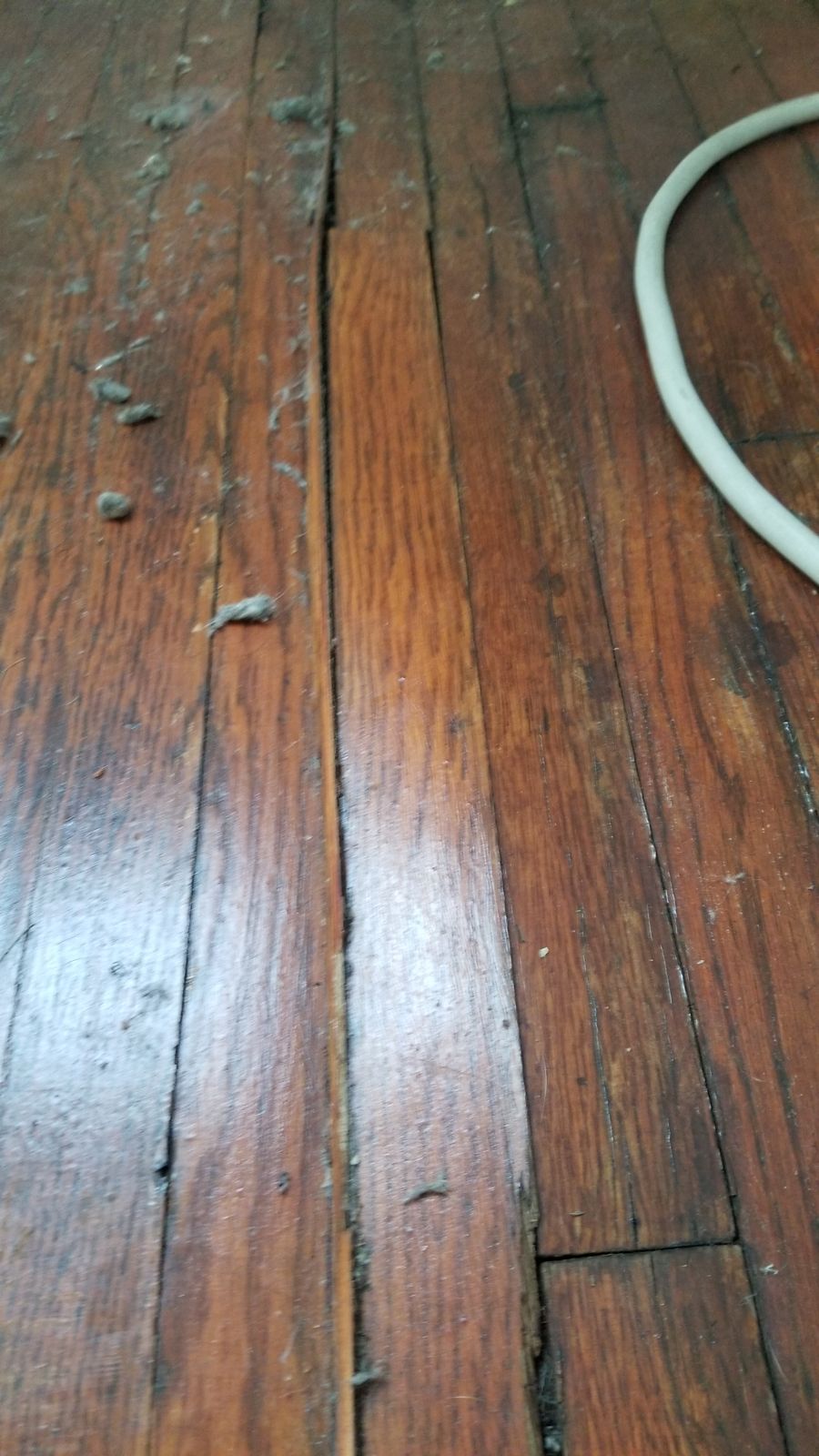 Before: worn and damaged hardwood boards