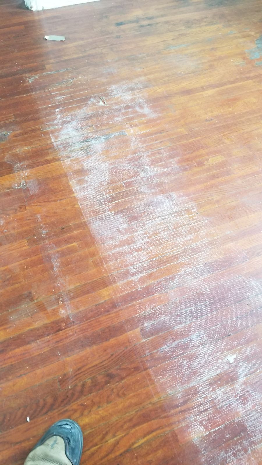 Before: stained and scuffed hardwood floor