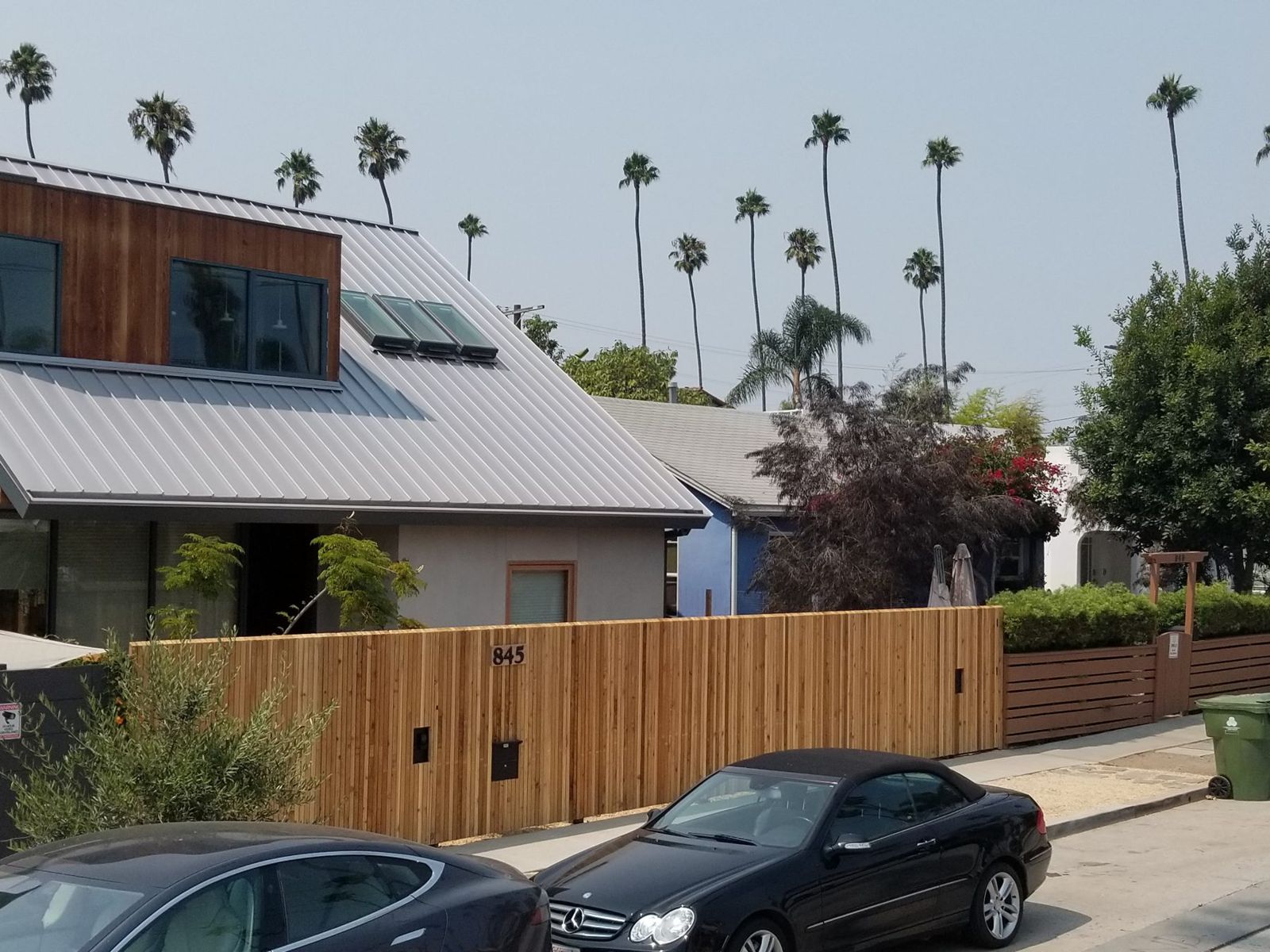 Street view of the wood fence in front of a modern home