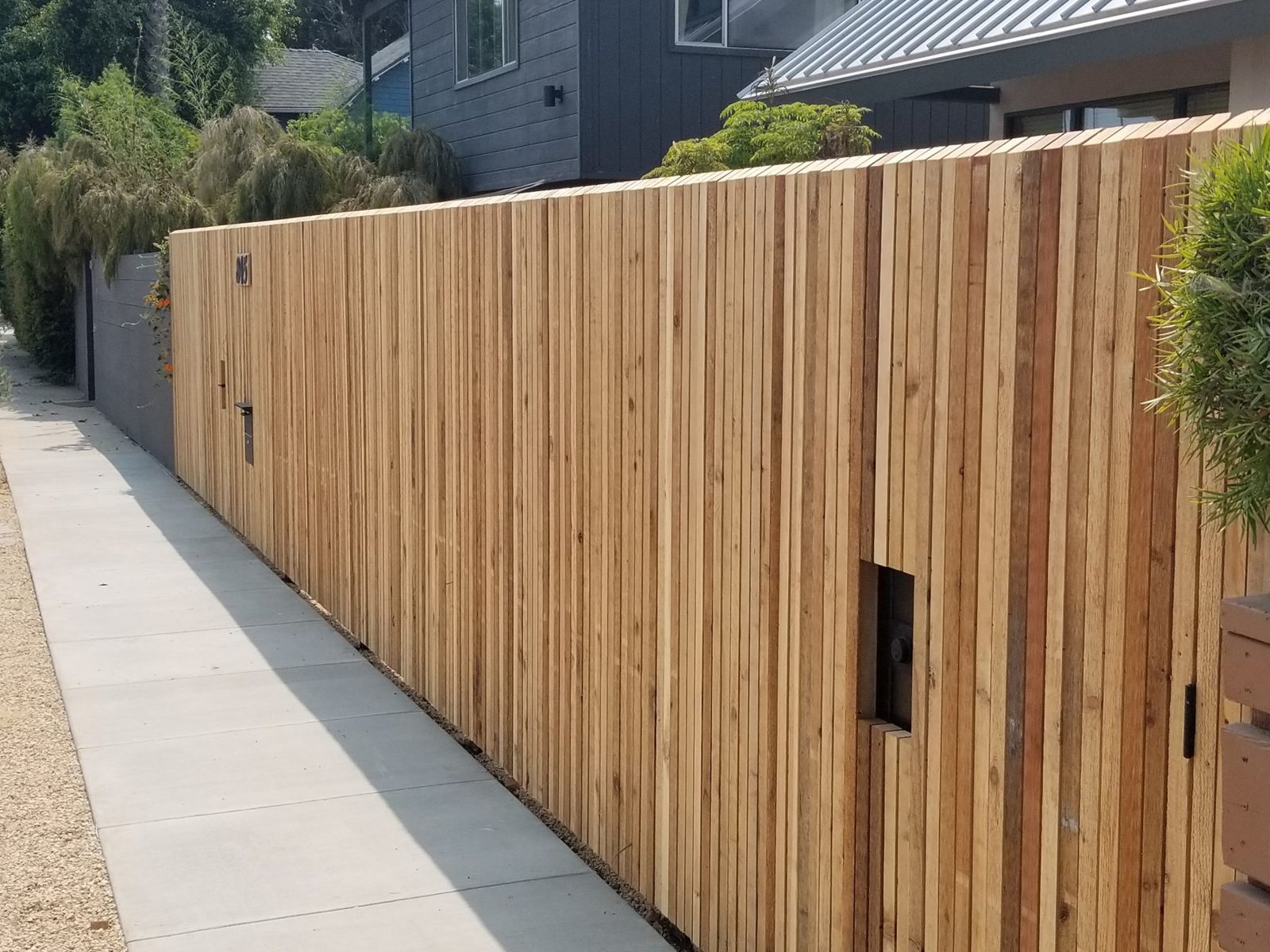 Wood fence with a built-in gate along the side yard